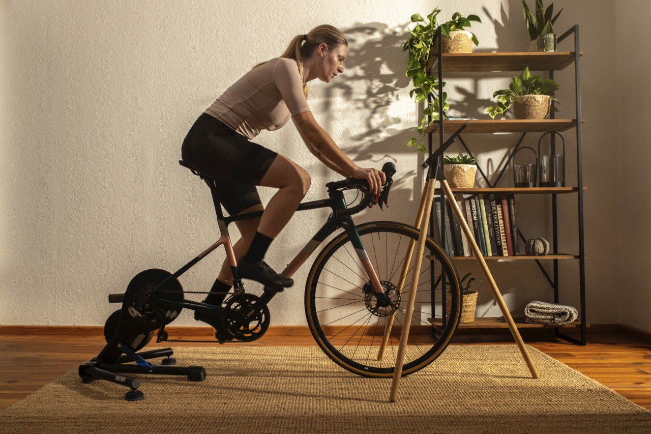 Woman sitting on indoor cycling bike.