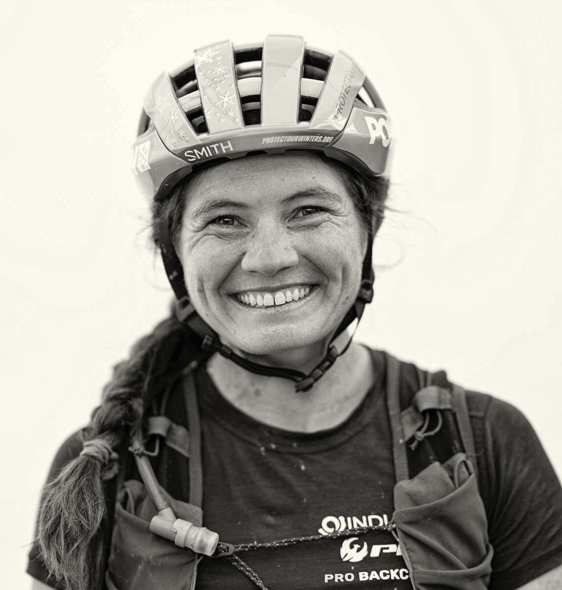 Portrait of Kait Boyle smiling with a black and white filter
