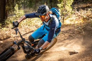 Ergon Mountainbiker im Wald auf einem Trail.