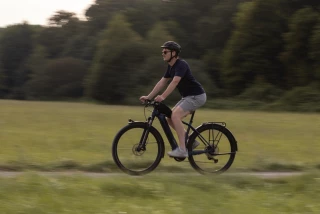 E-Bike country lane Man riding an e-bike along a country lane.
