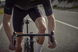 Ergon Why are stretching exercises important for cyclists Cyclist in motion on a racing bike, close-up of legs and bike