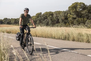 Touring country road Man riding his e-bike along a country road.